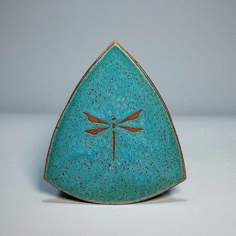 Teardrop Vase, 2026. Speckled stoneware, turquoise matte glaze, dragonfly motif. 6.25"W, 7.25"H, 3.25"D