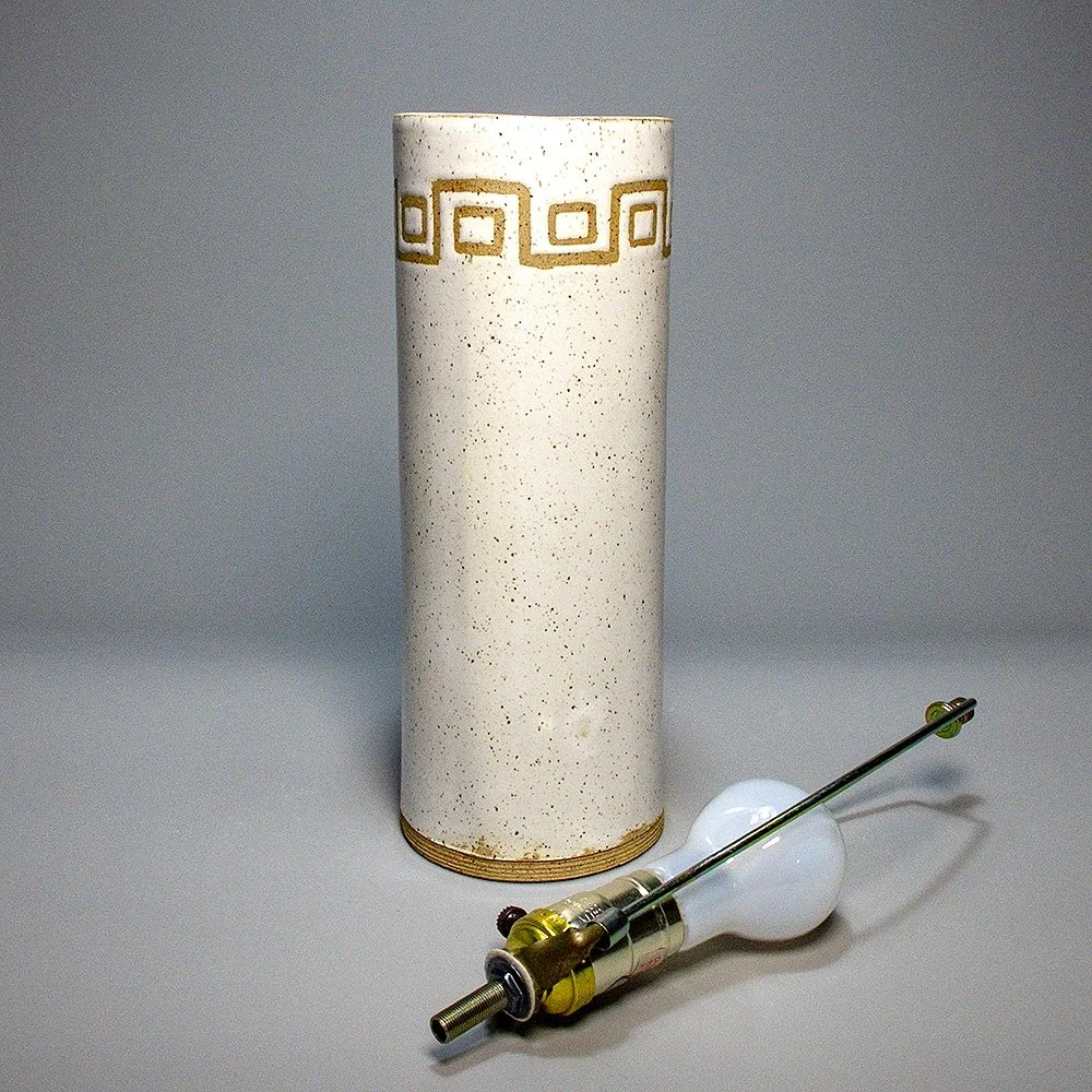 Cylinder Lamp Base 2026. Speckled stoneware, white glaze, Greek-key inspired geometric motif. 12"H, 4.5"Dia.