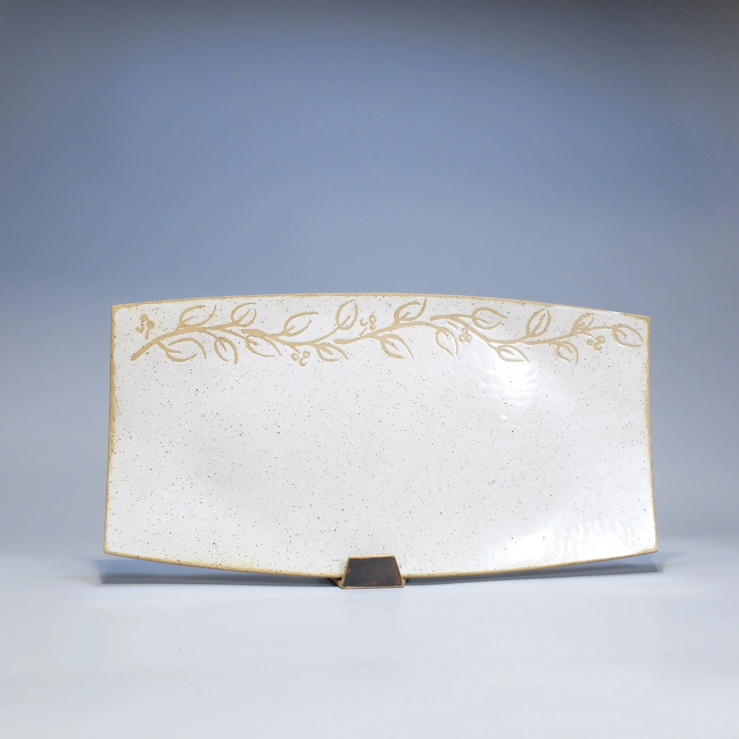SOLD Platter, 2026. Speckled stoneware, white glaze, leaf & vine motif. 17.25"L, 8.75"W, 0.75"D.