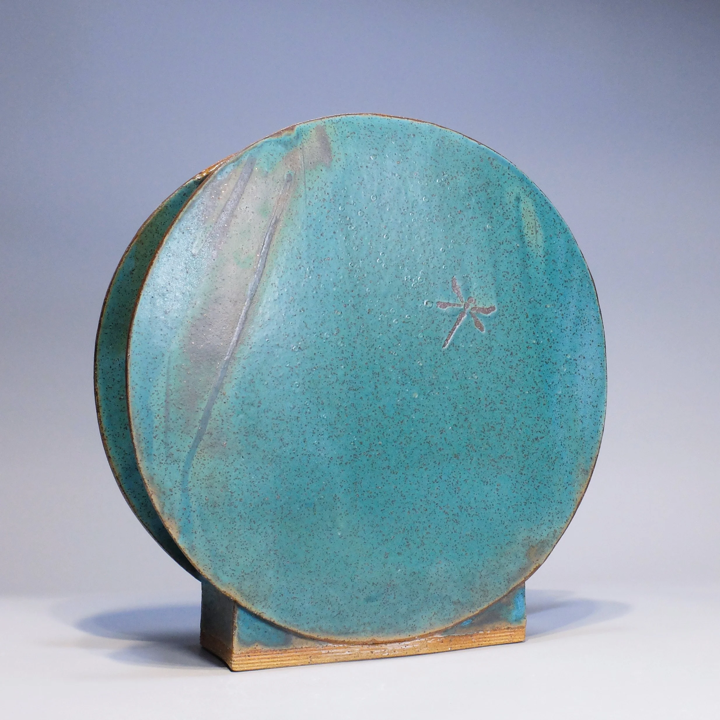 Full Moon Vase, 2026. Speckled stoneware, turquoise matte glaze, dragonfly motif. 12"W, 12"H, 3"D.