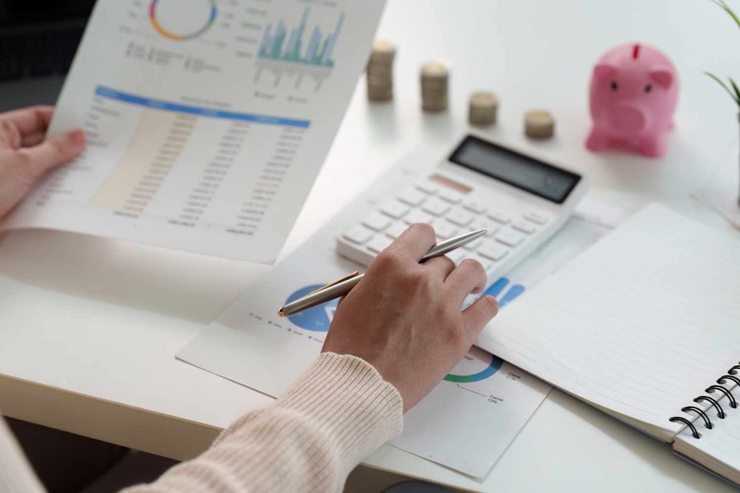 Person reviewing financial documents and property information representing the home valuation process for sellers.