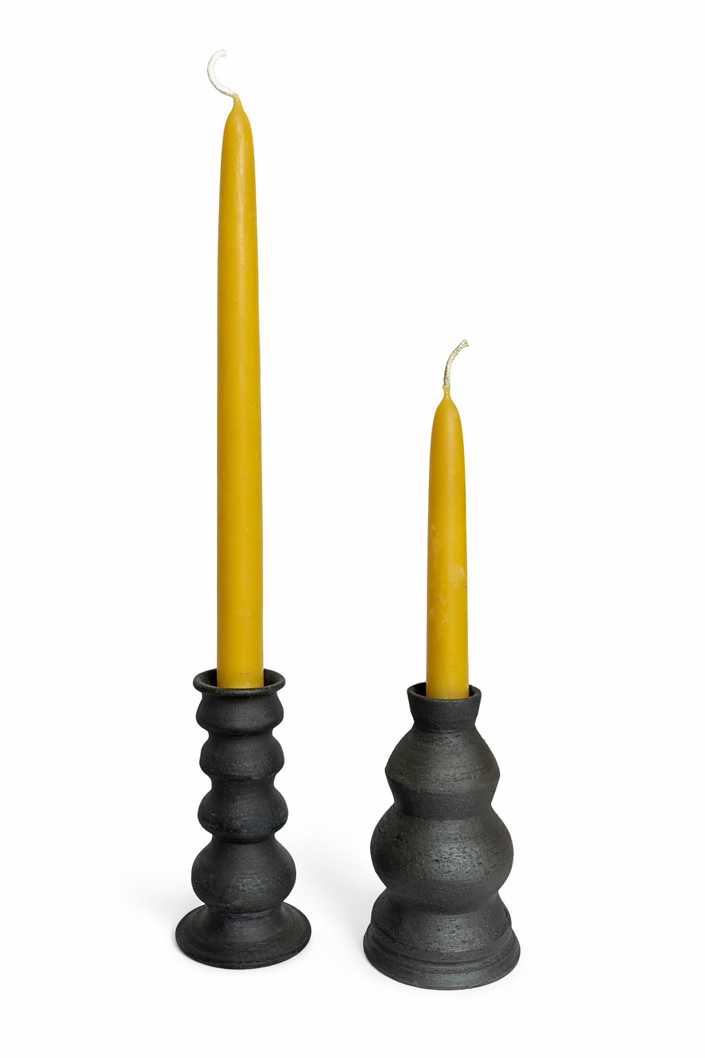 pair of yellow candles in black holders