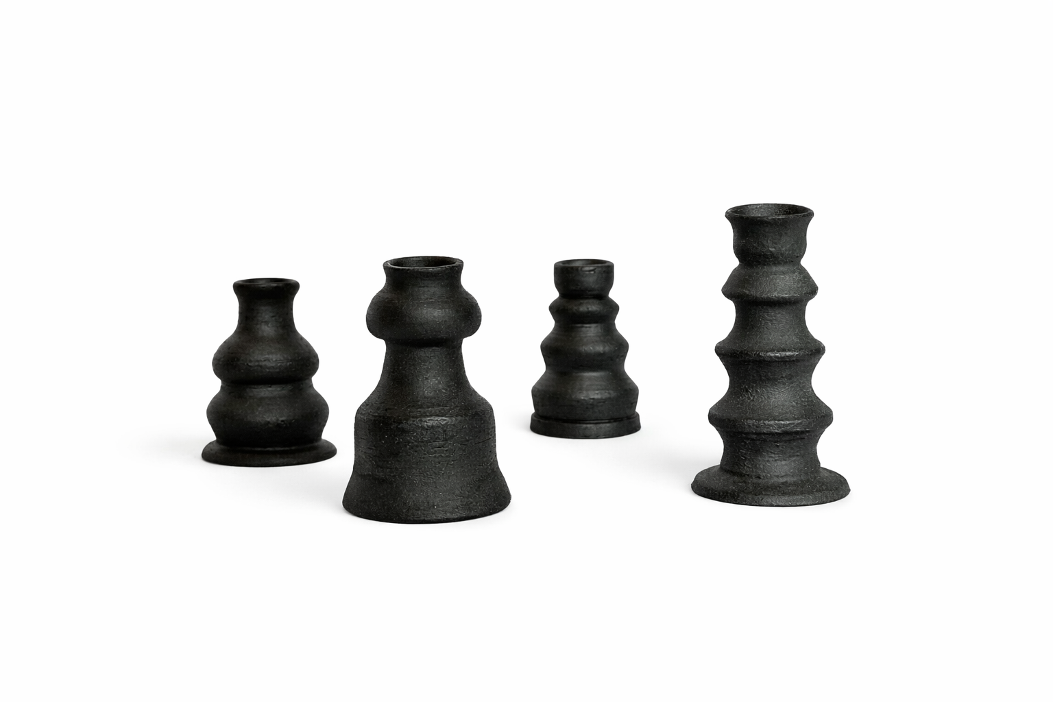 a collection of four black candlestick holders