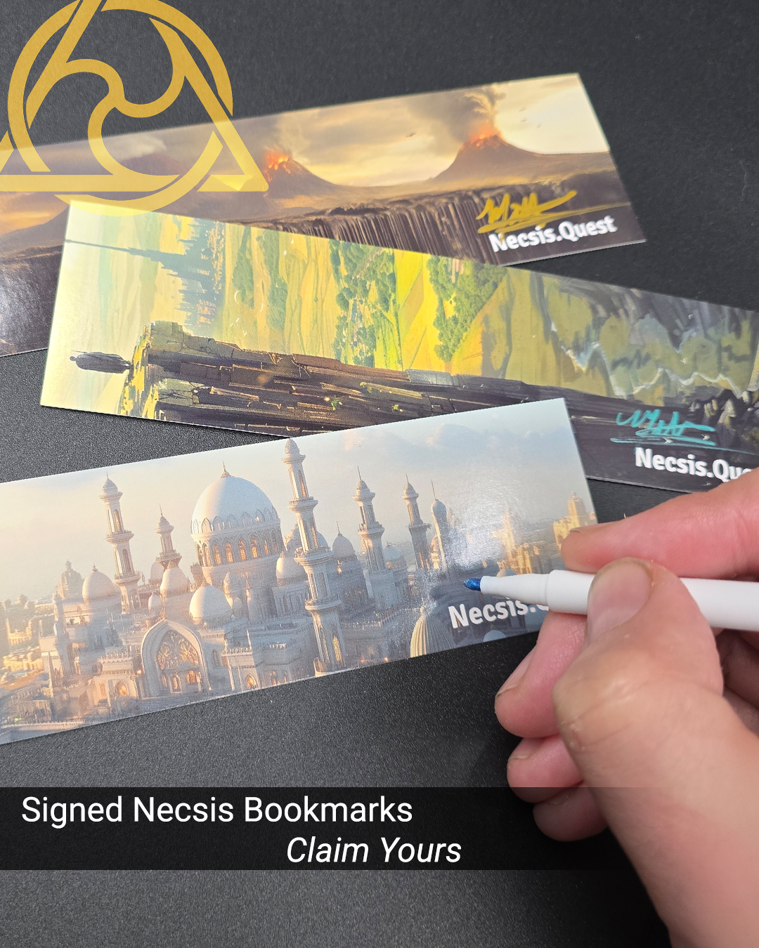 Person holding a white marker and signing a Necis bookmark with a blue signature, while two other signed Nescis bookmarks with fantasy and landscape illustrations lie on a black surface.