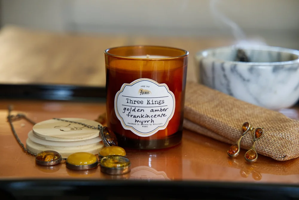 Three Kings candle in amber glass with amber jewelry, smoking resin and burlap