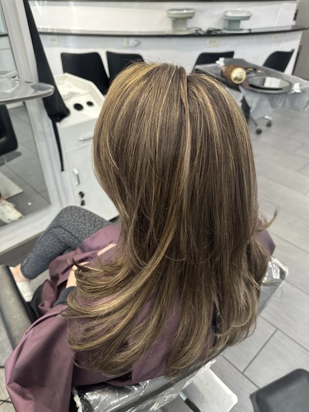 Woman's shoulder length brunette hair with bright highlights freshly applied