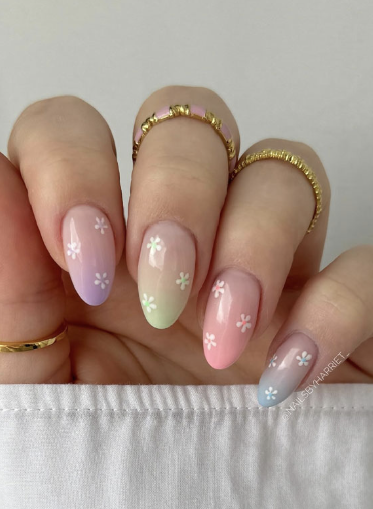 mismatched nails where each individual finger has a different color but they make up a pallet together and have small flower details that unite them