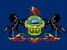 The image depicts the flag of Pennsylvania, featuring two black horses facing each other, a blue shield with a ship, a plow, and three sheaves of wheat, topped by an eagle, all on a blue background.