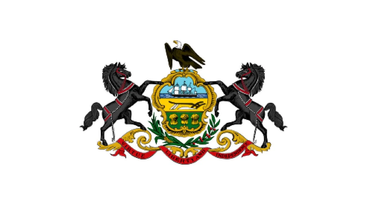 Flag of Pennsylvania, featuring two black horses, a shield with a ship, mountains, and wheat, topped by a bald eagle, with a ribbon reading 'Virtue Liberty and Independence'.