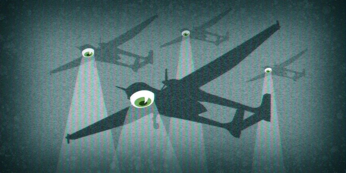 A drone's shadow cast on a wall, with three small circle-shaped lights shining downward, creating the appearance of eyes and three spots.