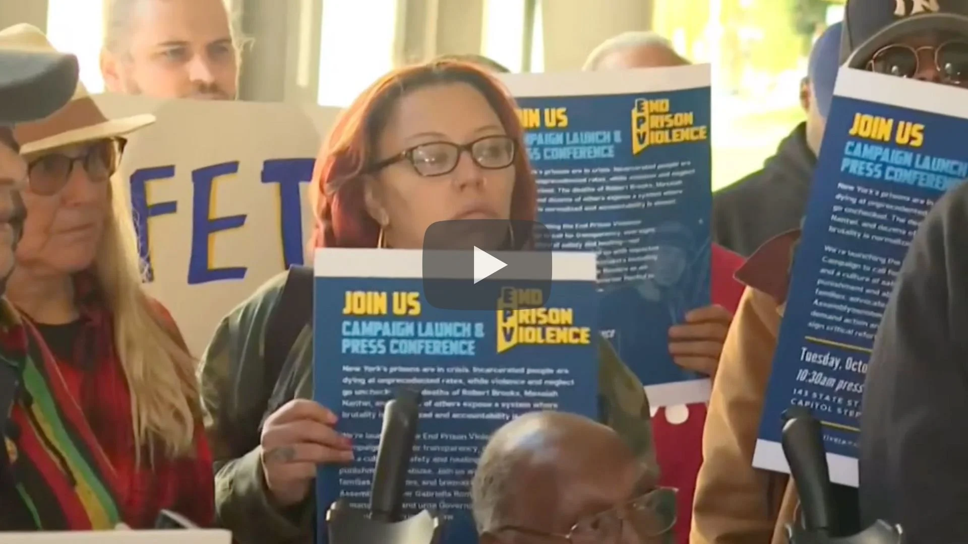 Woman holding an End Prison Violence sign