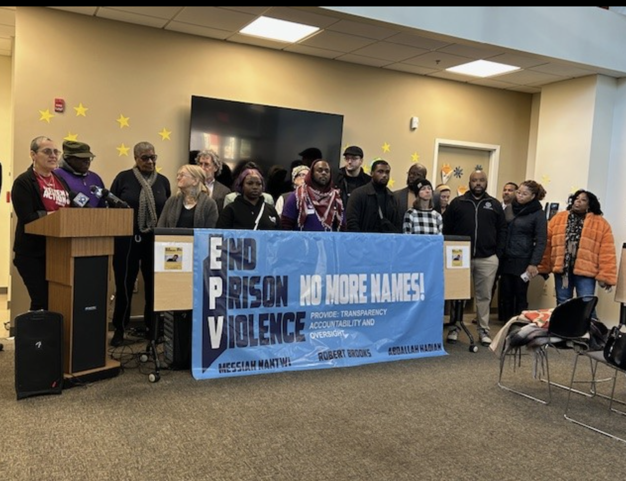 Group holding an End Prison Violence banner