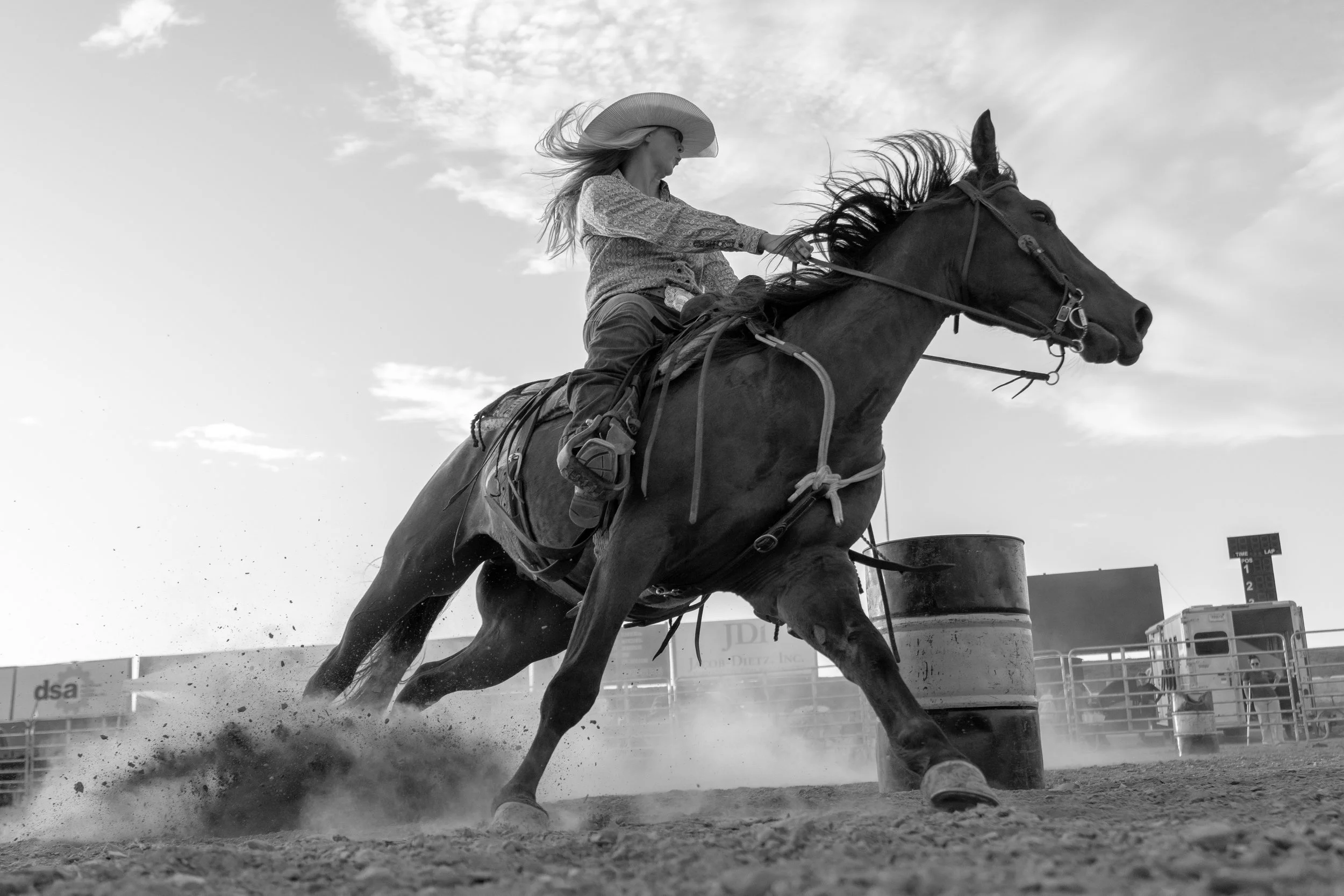 A Barrel racing competitor is racing in an arena at a county fair.