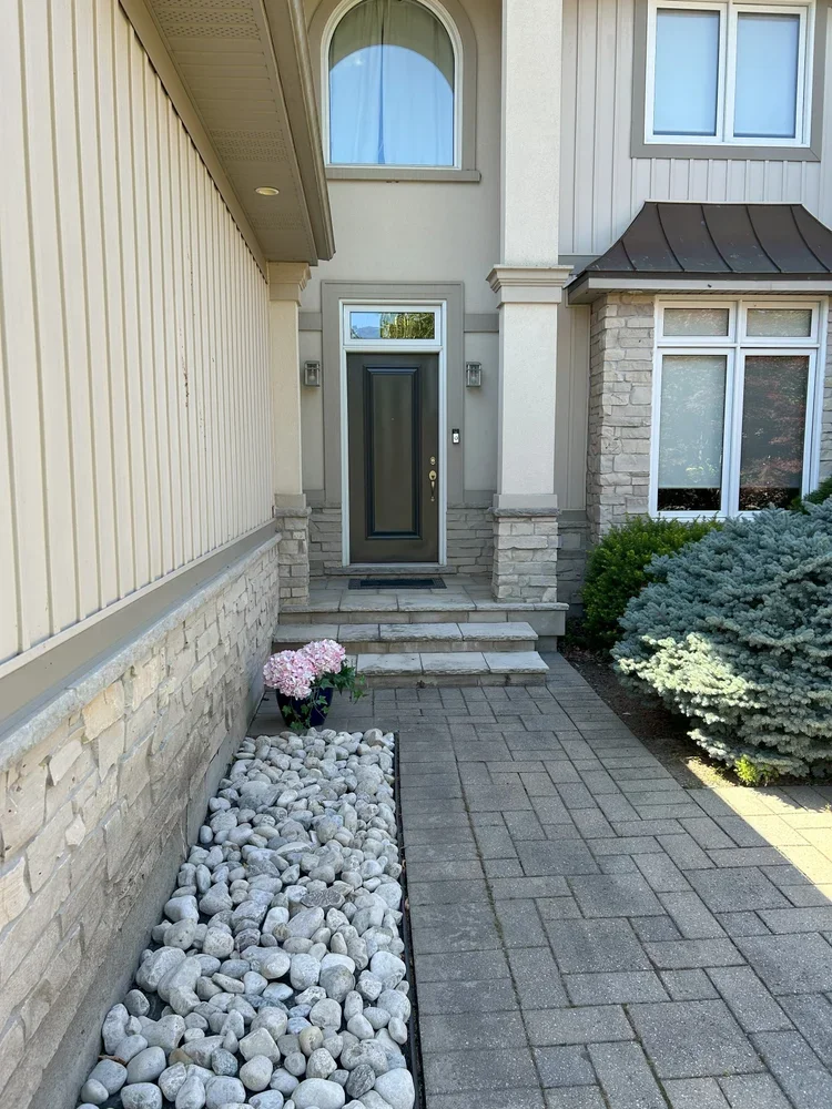 Side of house and dark painted door