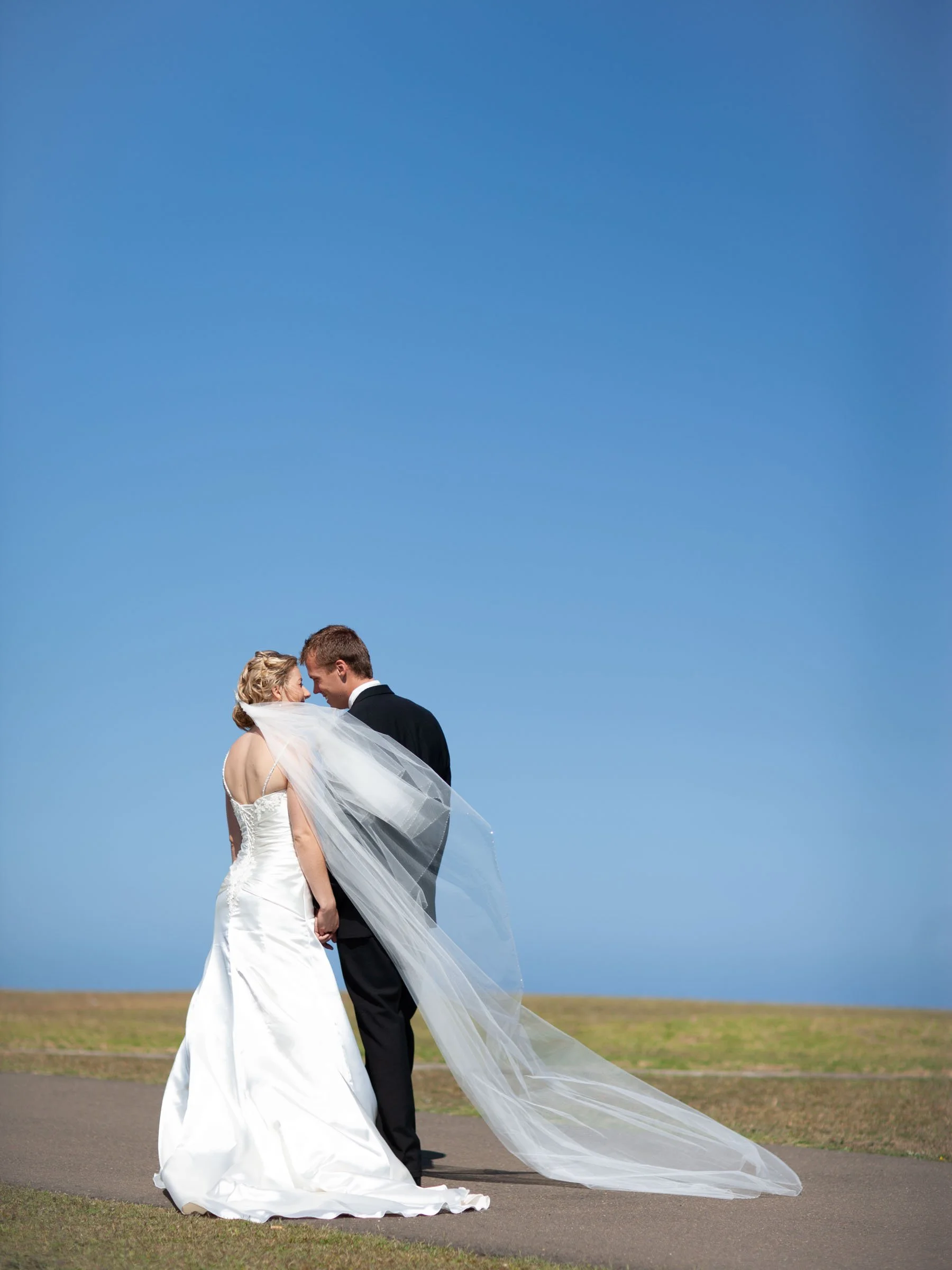 Naomi & Justin stop for a quiet moment with a flowing veil walking at their wedding portraits in Vaucluse