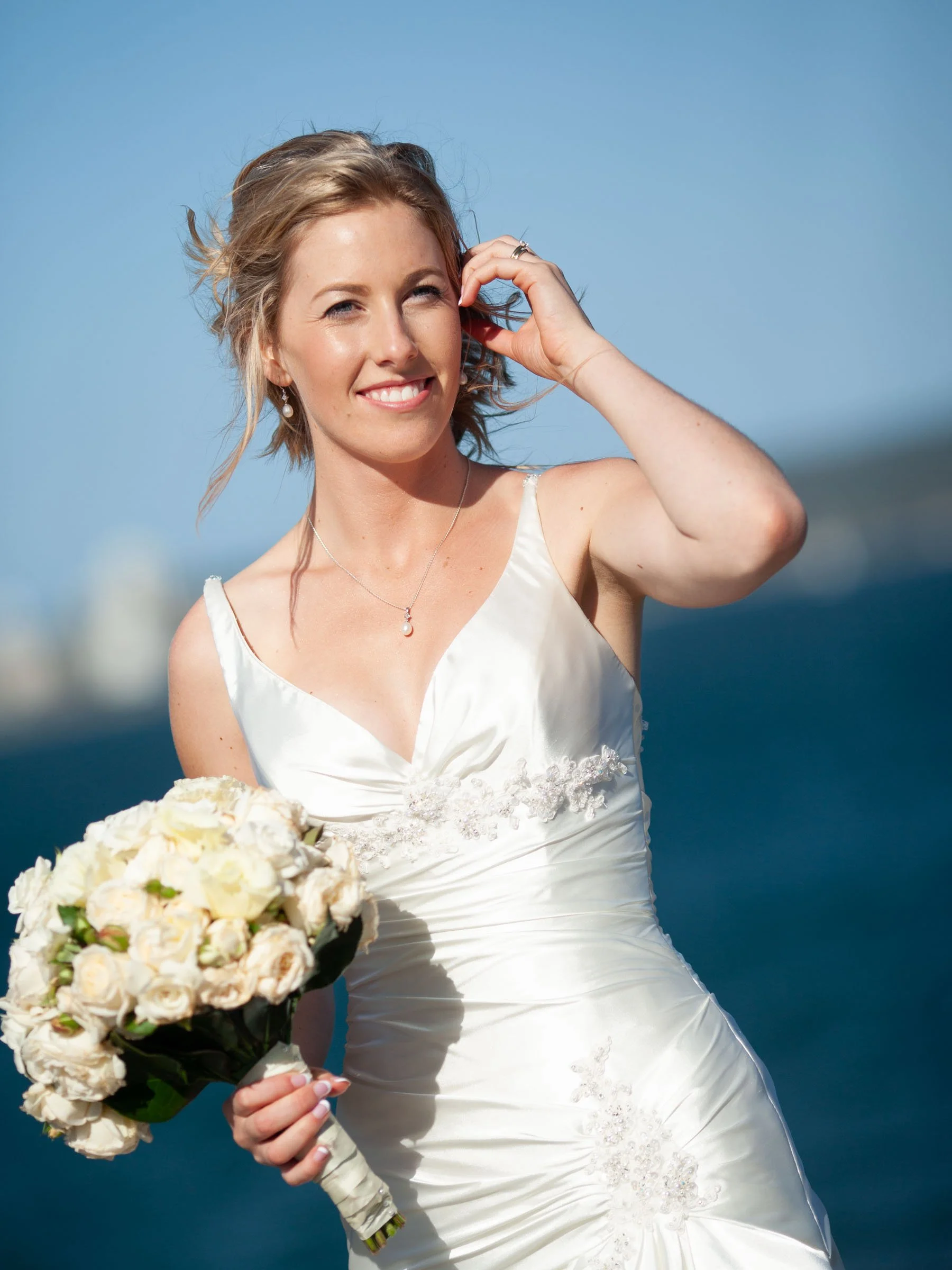 A candid portrait of Bride Naomi at the Balmoral Beach during her wedding location portraits