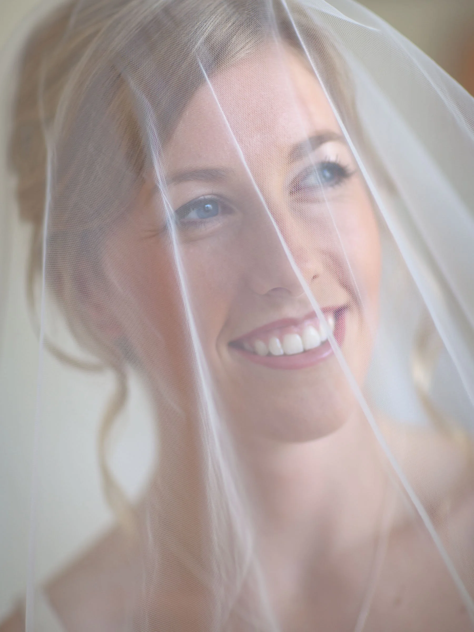 Bride Naomi smiling under her veil with bridesmaids Sydney summer wedding