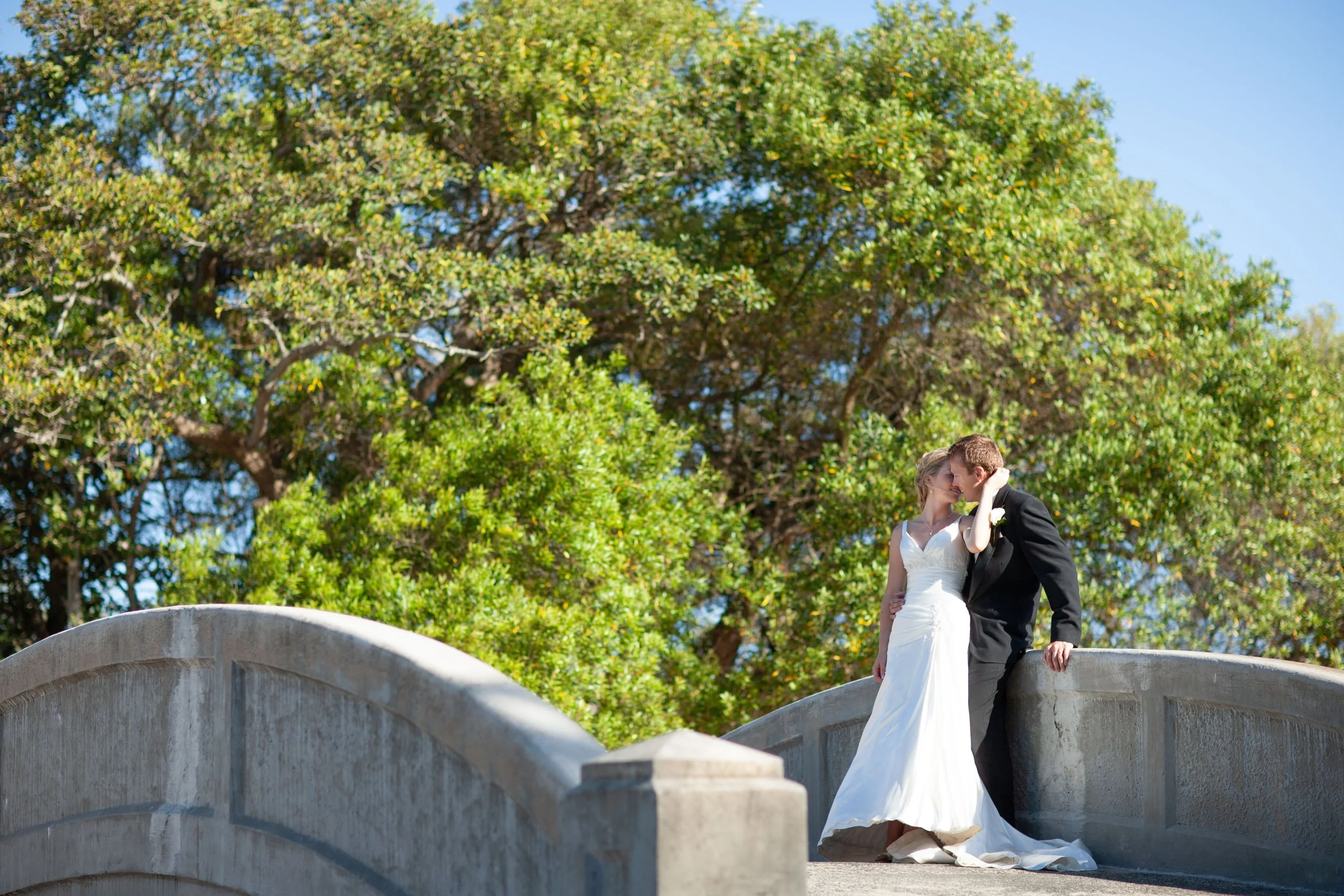 A tender moment at the Balmoral Beach bridge at the bridal location shots Sydney summer wedding