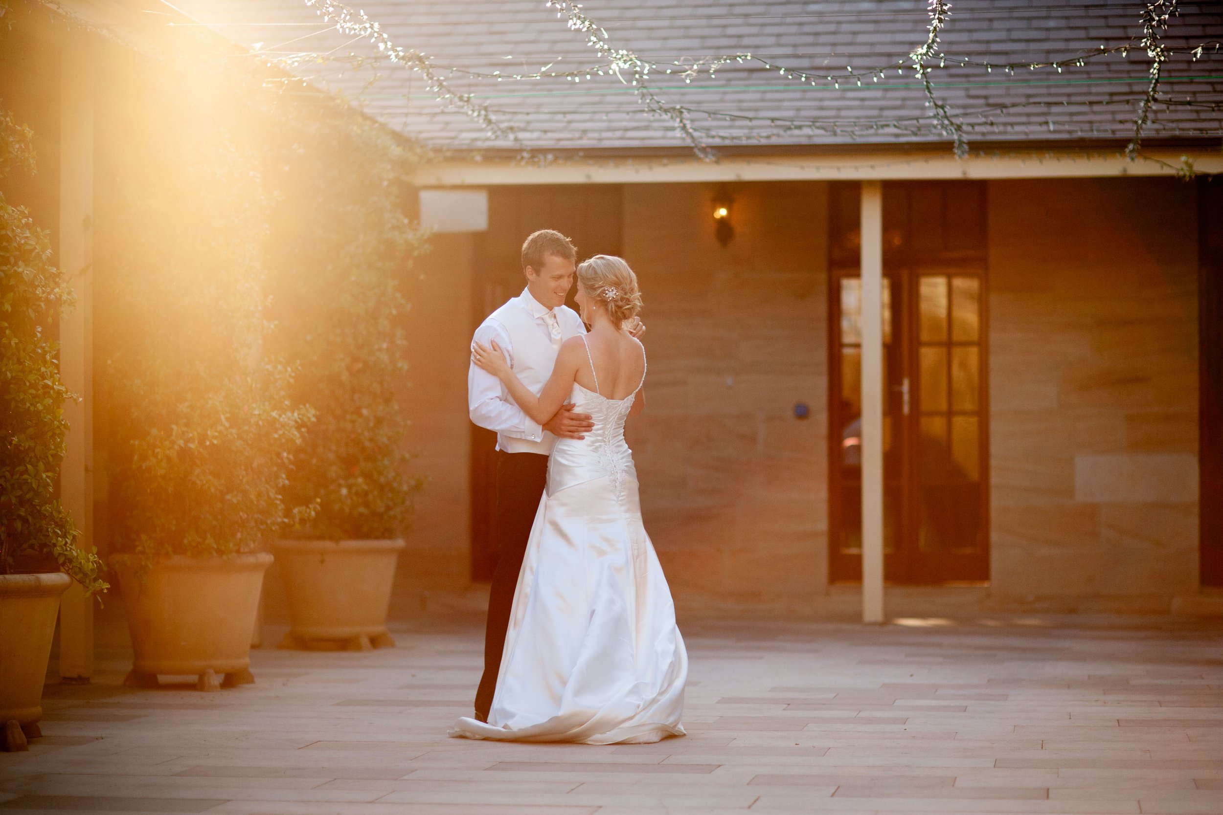 Naomi and Justin enjoy a quiet and private outdoor courtyard bridal dance as the sun sets behind them at their Gunners’ Barracks reception