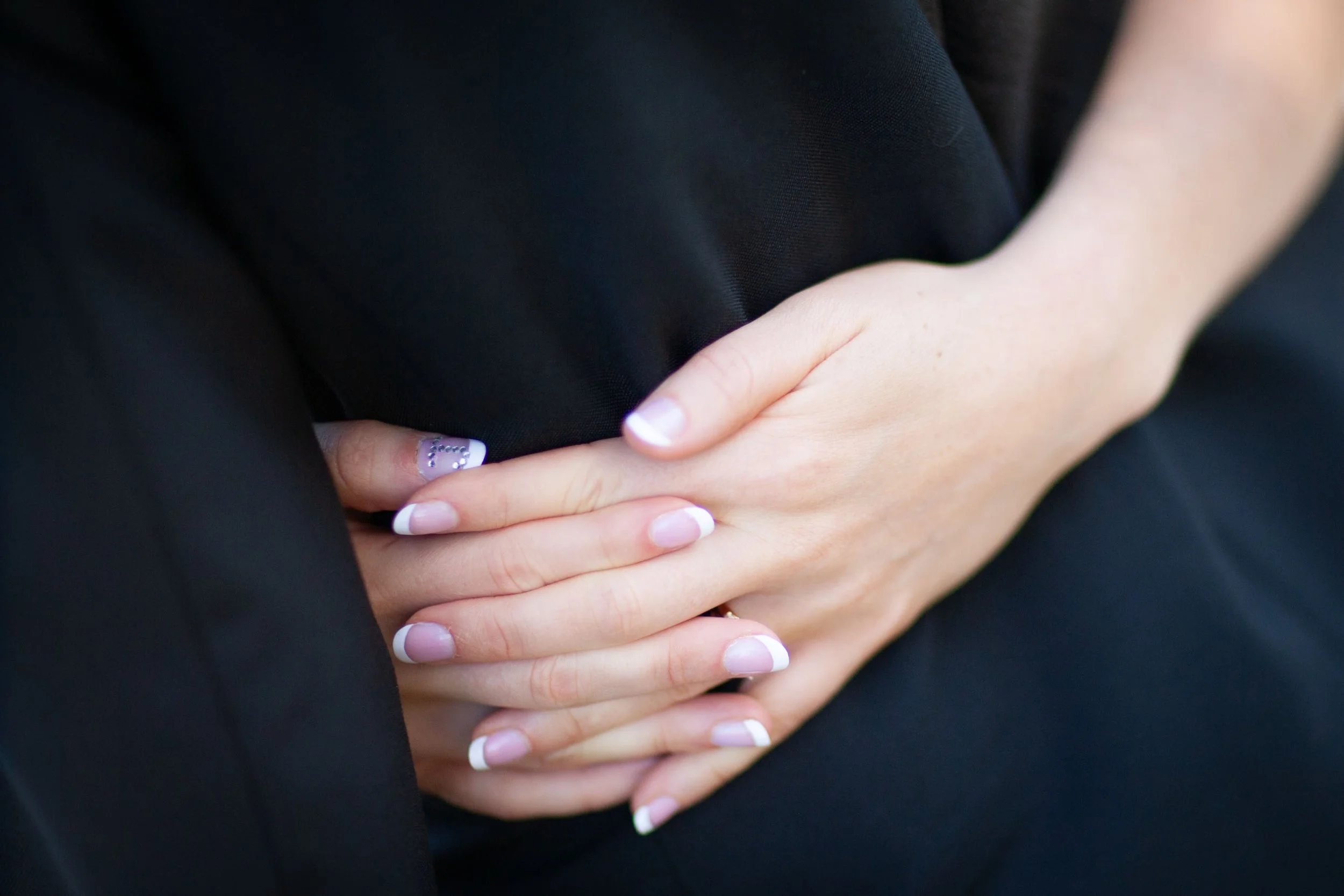 Closeup of the Brides nail around her husband at their wedding portraits at Balmoral Beach