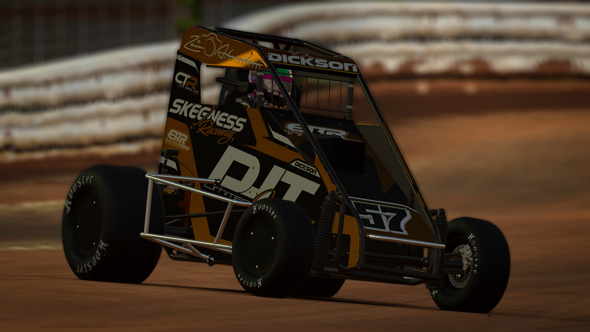 A black and gold sprint car racing on a dirt track with the driver wearing a helmet and the background showing a blurred dirt barrier.