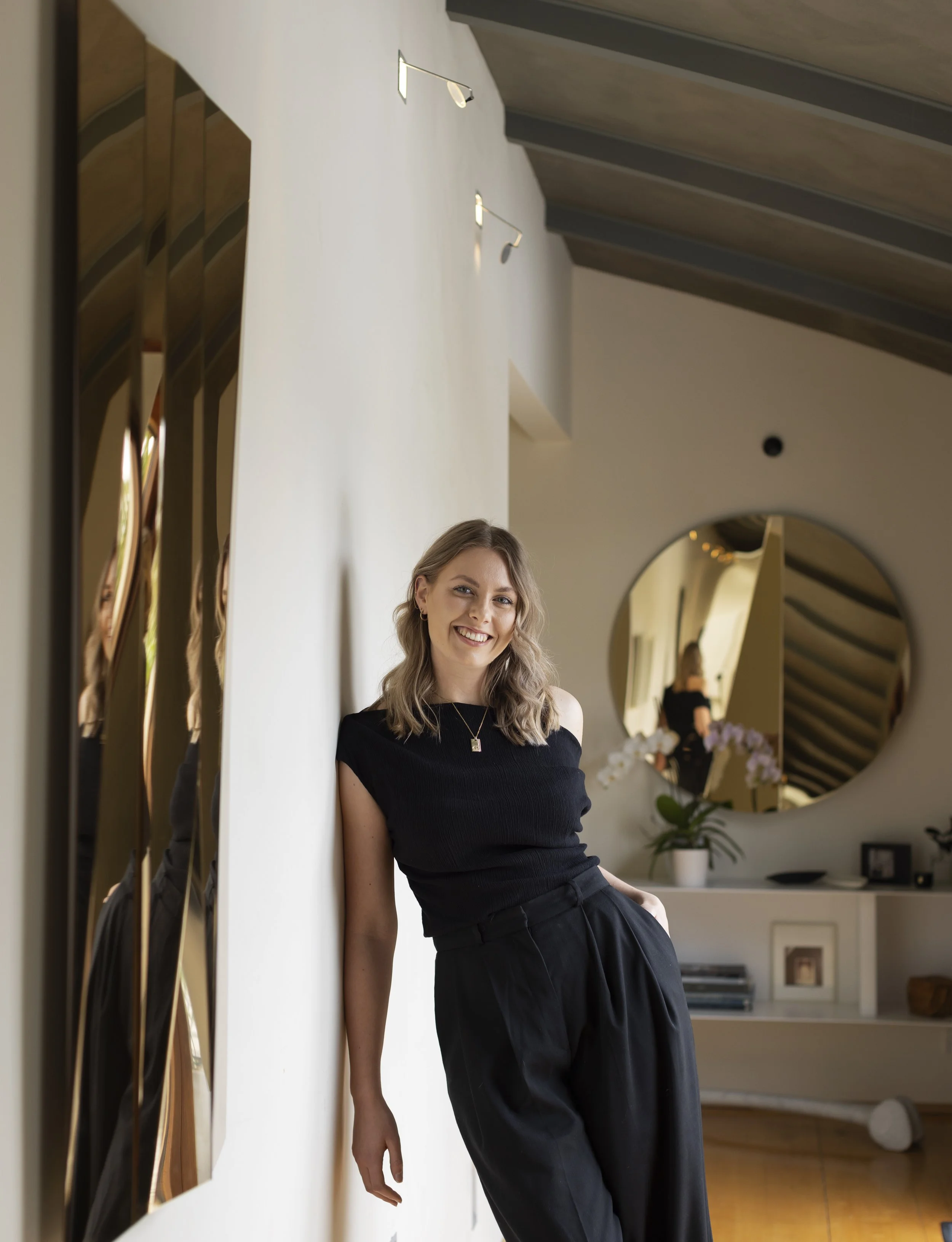 Artist Lily Custance with two of her mirrored sculpture works.