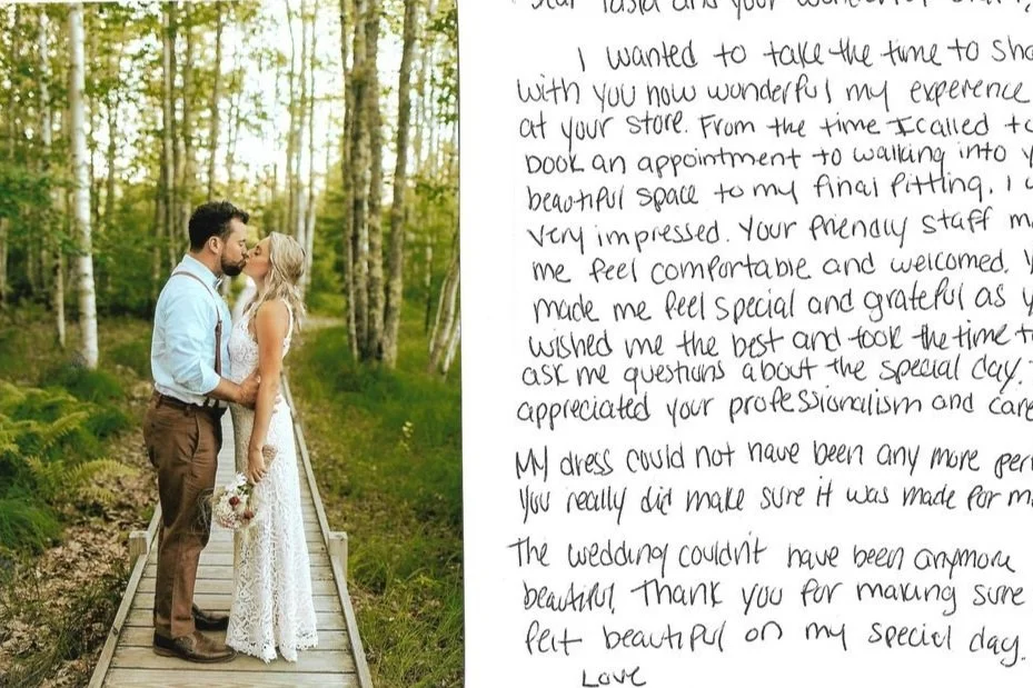 A couple kissing on a wooden path in a lush green forest during daylight, with a handwritten letter visible in the background.