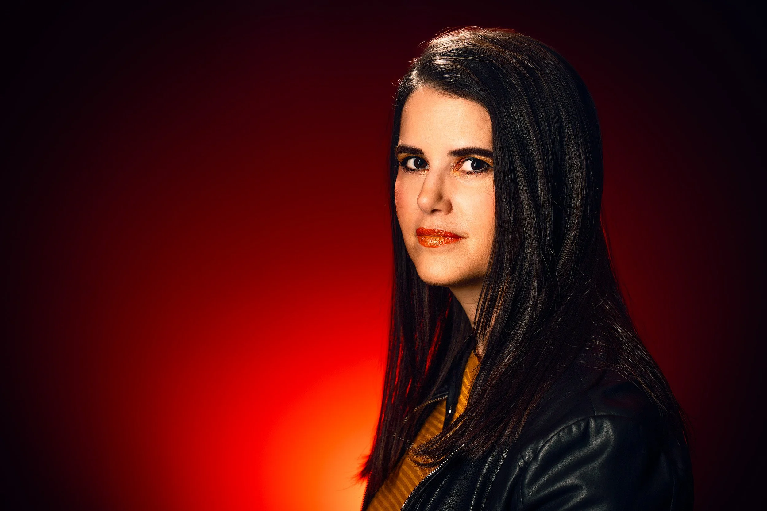 editorial studio portrait of woman with red background lighting – Calgary portrait photography