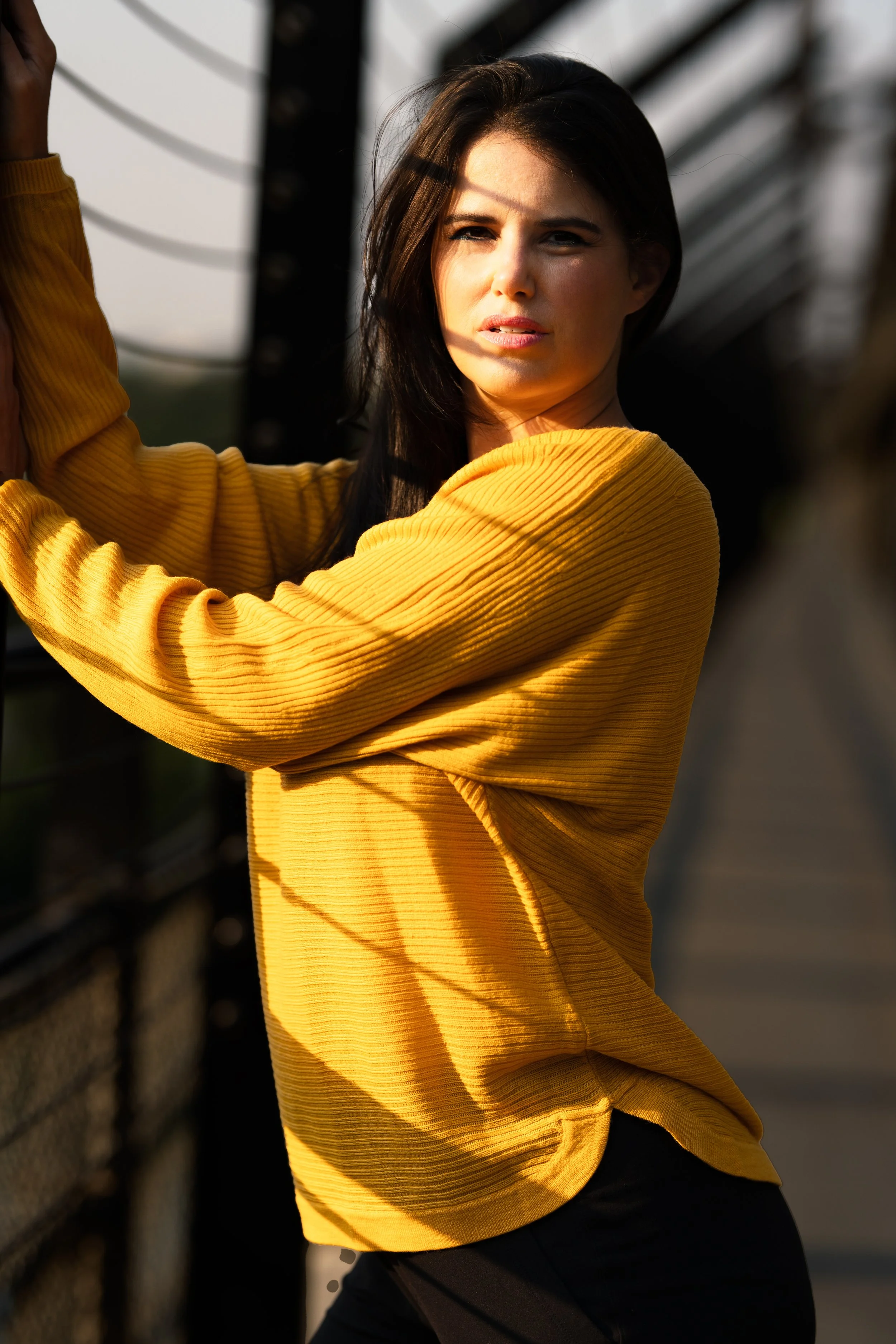 editorial outdoor portrait with dramatic sunlight and urban backdrop – Calgary fashion photography