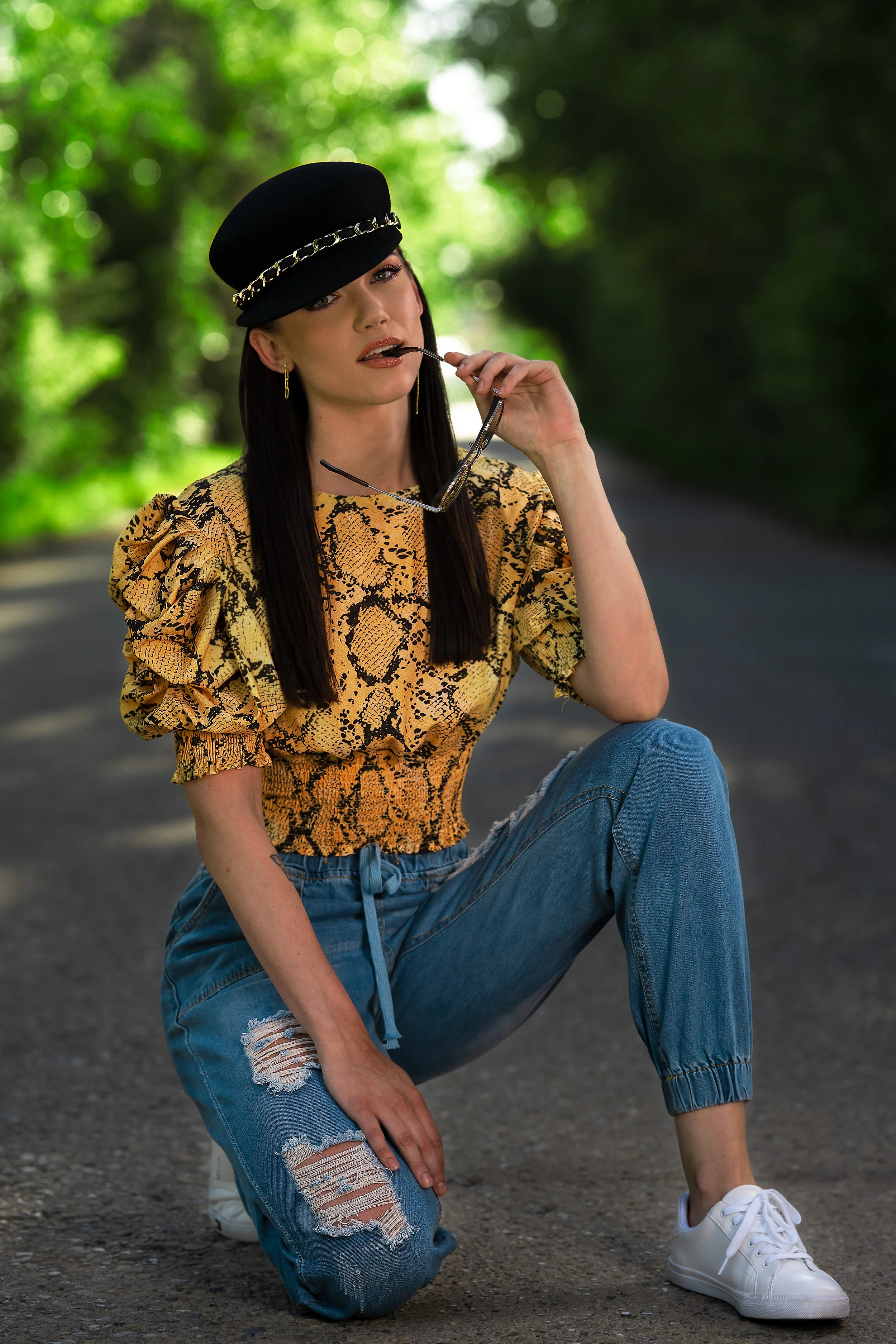 editorial outdoor portrait of woman posing on sunlit road – Calgary fashion photography