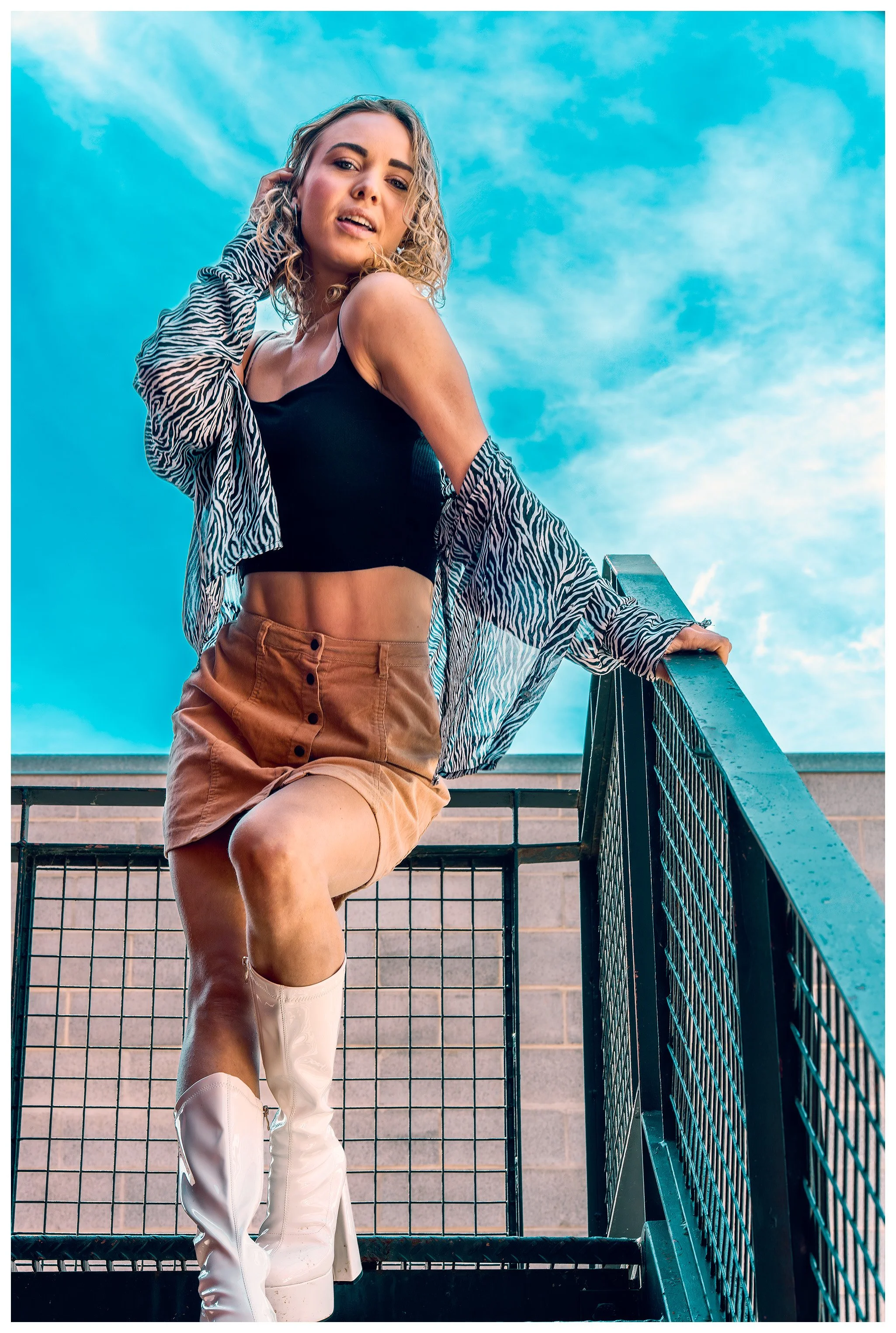 editorial style portrait of woman posing outdoors with dramatic sky – Calgary fashion photography
