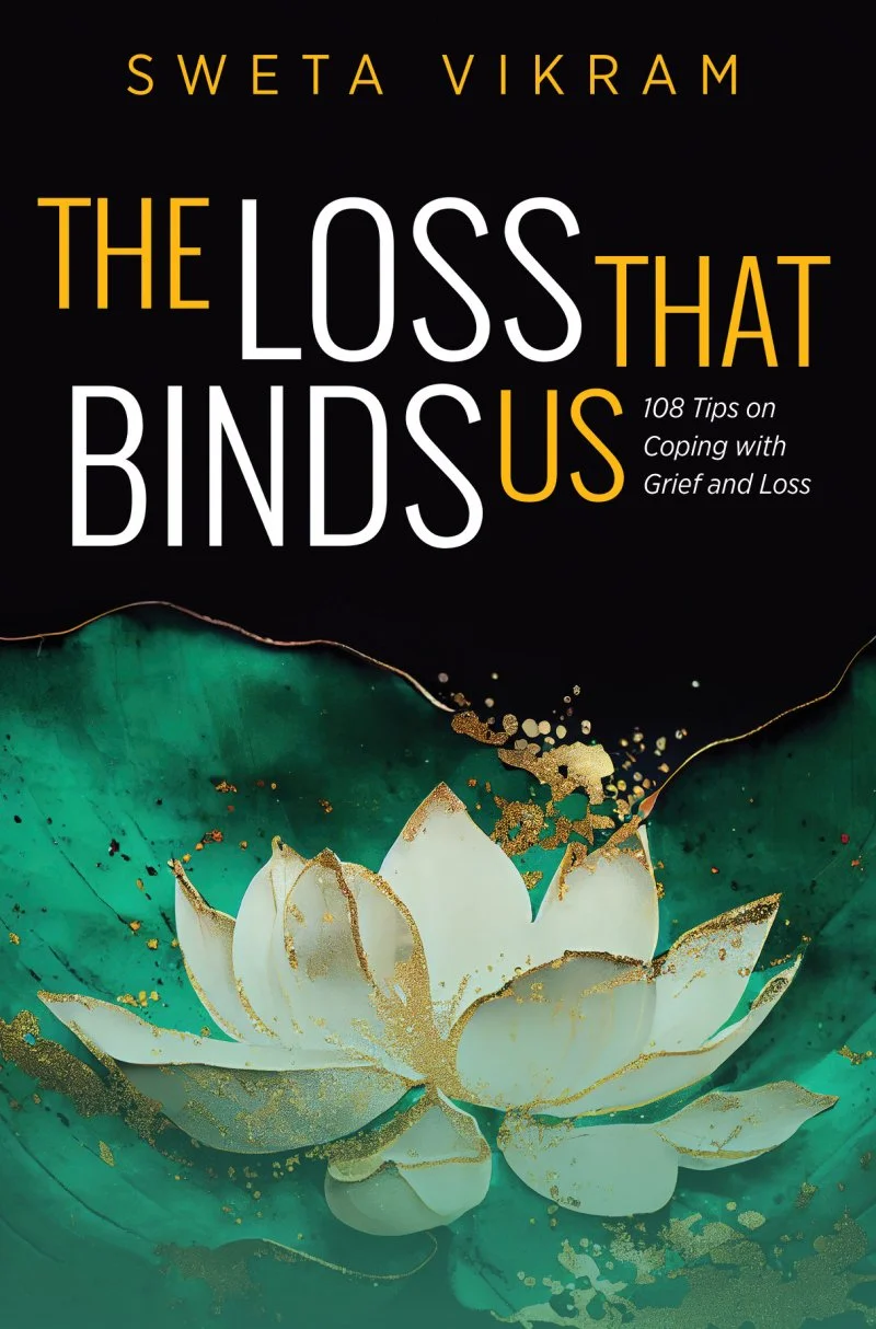 Book cover with black background, gold and white text, featuring a white lotus flower with gold accents on a green and gold abstract background. Title: 'The Loss That Binds Us,' by Sweta Vikram, with subtitle '108 Tips on Coping with Grief and Loss.'