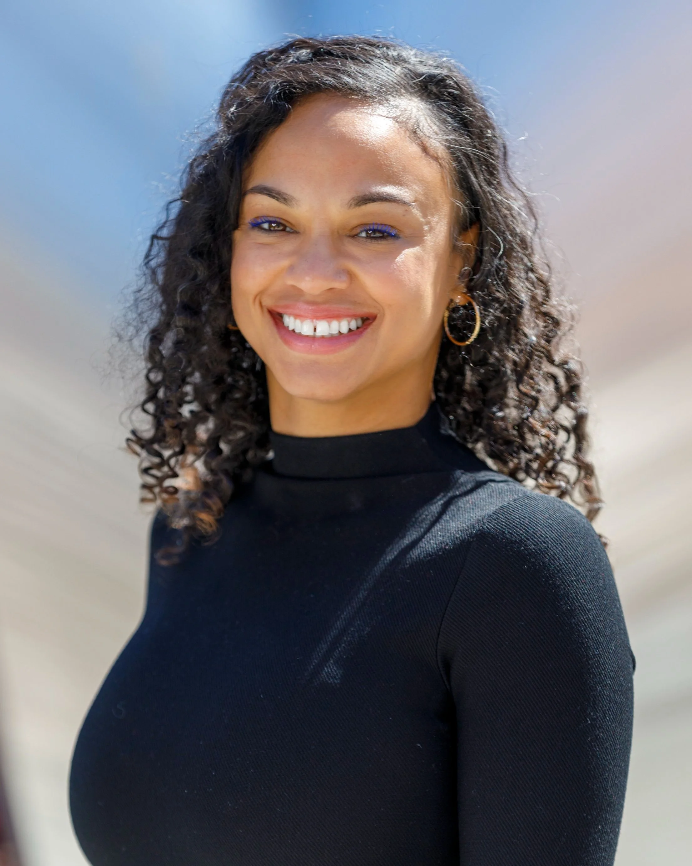 Terrica America poses with a smile for her 2025 Commencement Speaker graduation photo.