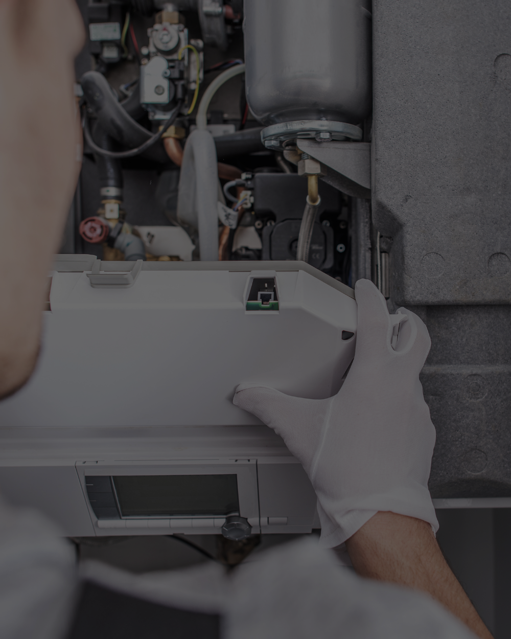 Technician replacing residential boiler and heating system equipment