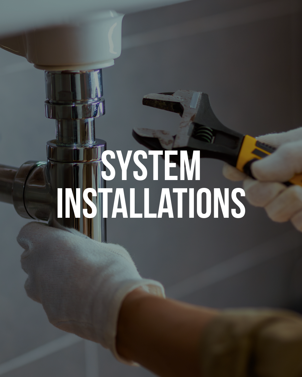 Plumber installing sink drain piping during residential plumbing installation