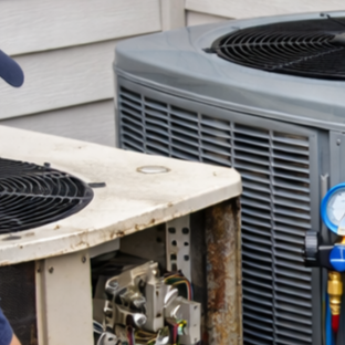 Technician replacing outdoor residential heat pump unit