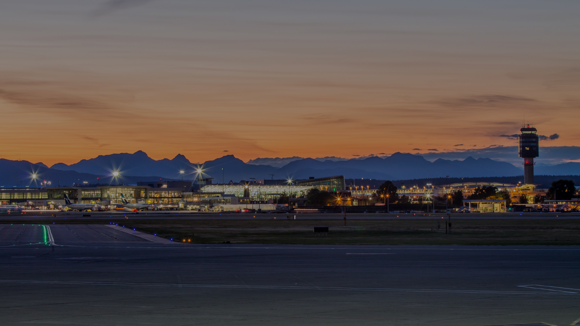 Vancouver International Airport terminal and control tower at sunset