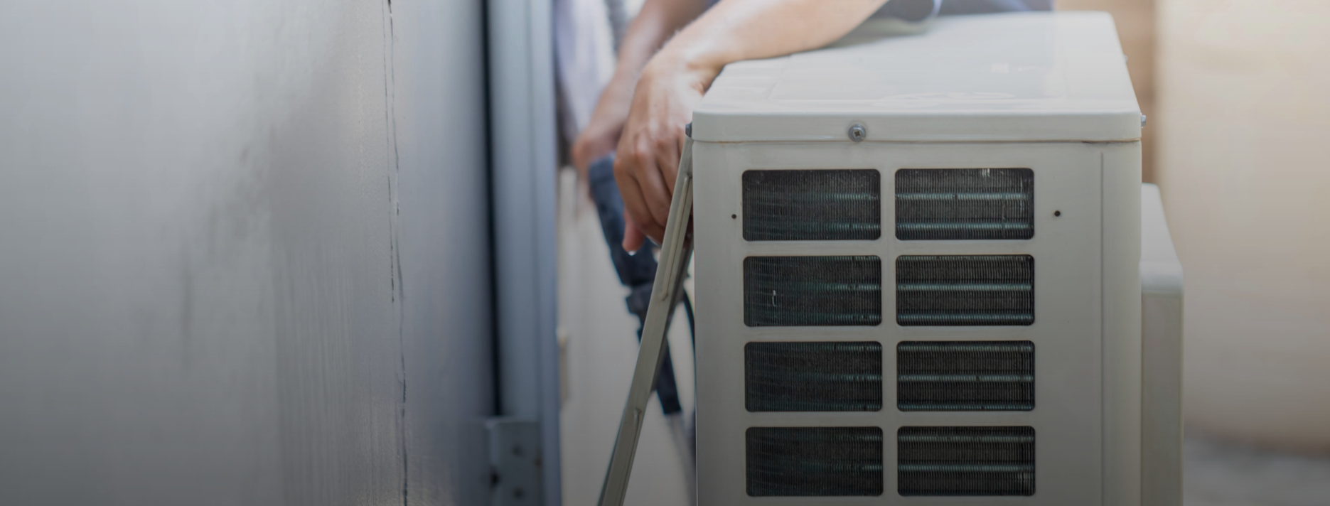 Technician performing preventative maintenance on outdoor HVAC unit