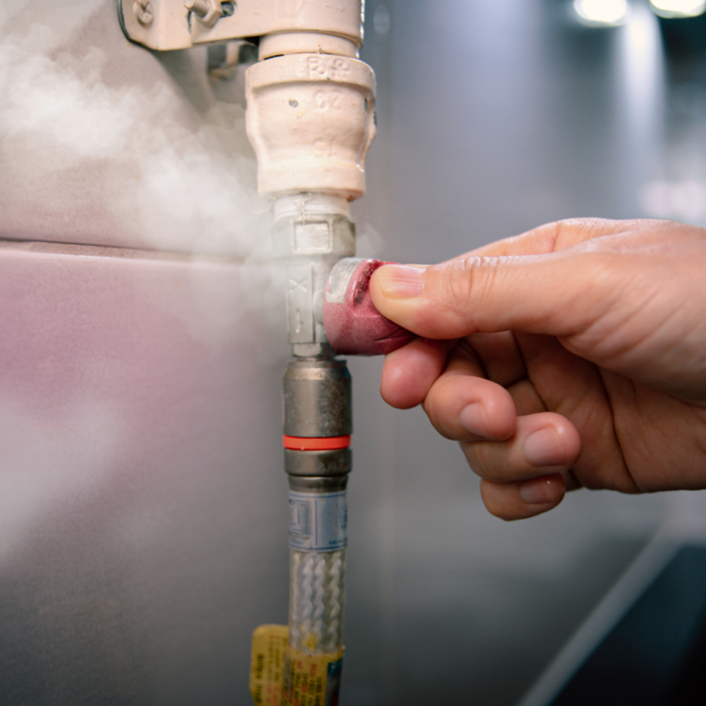 Technician performing gas line inspection and adjustment on residential gas piping