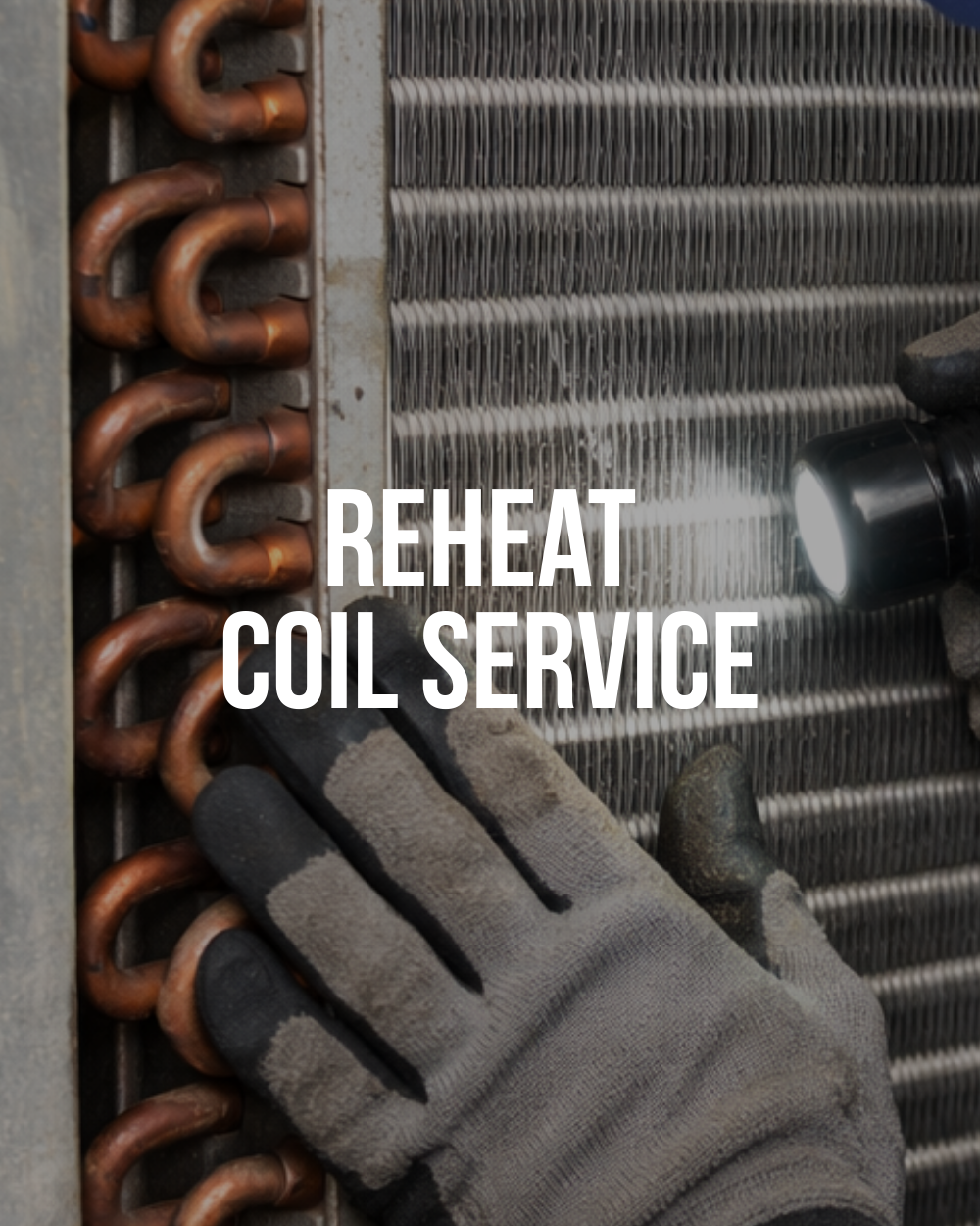 Technician inspecting hydronic reheat coil in HVAC system