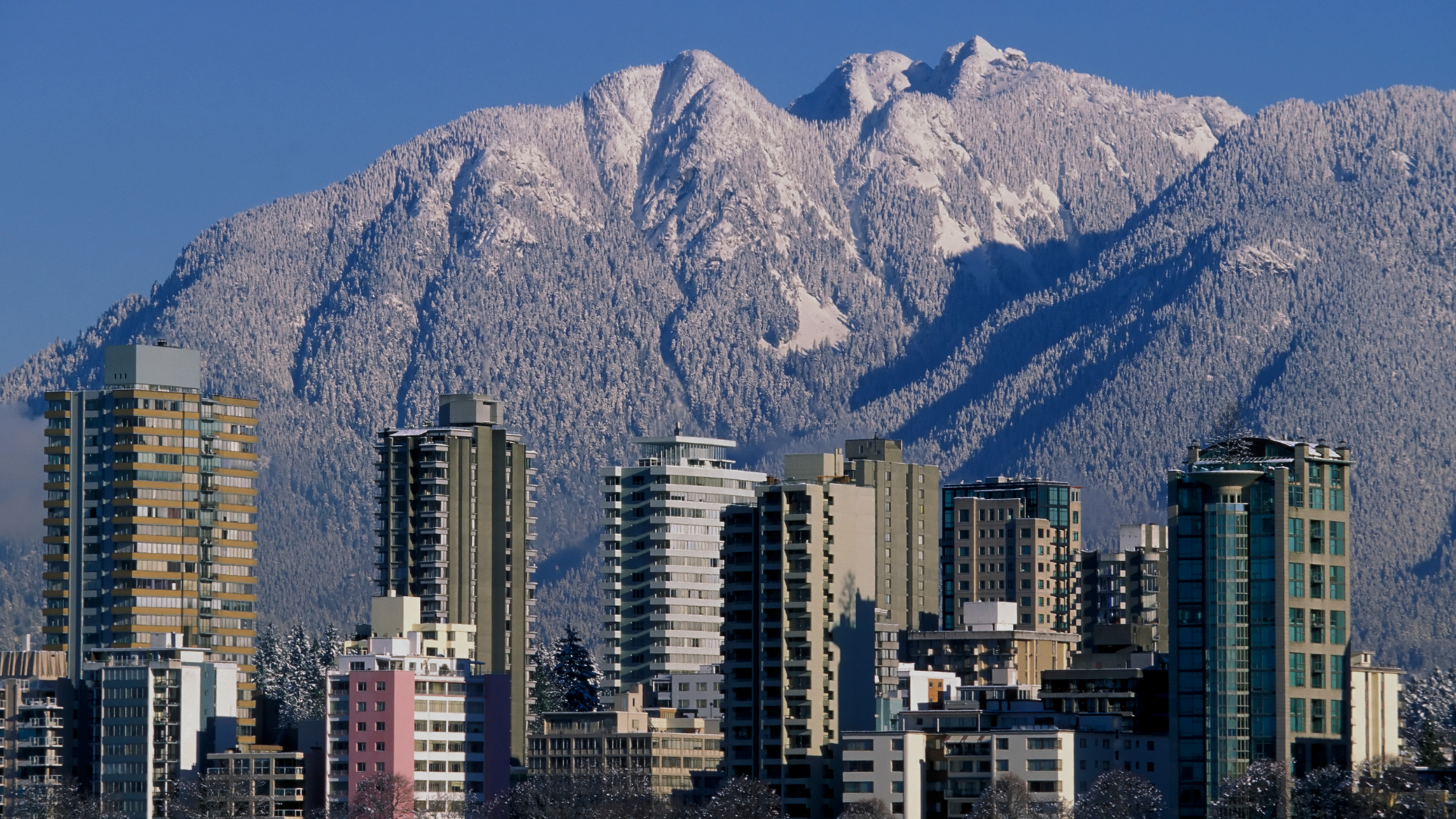 North Vancouver skyline with residential buildings and the North Shore Mountains in the background