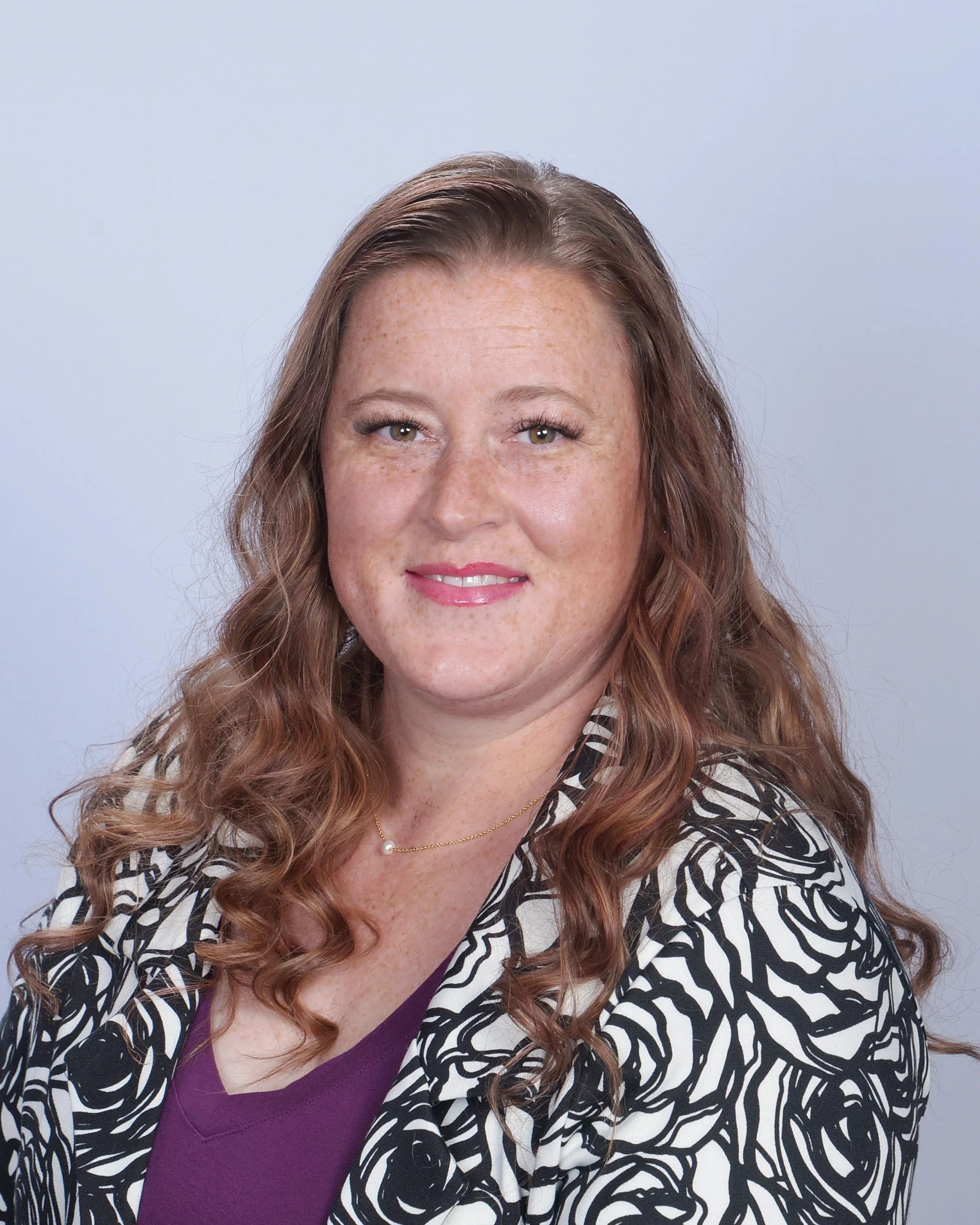 A woman smiles kindly about gestational surrogacy and the compensation benefits available for surrogate mothers.