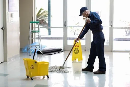 A professional cleaning technician performing maintenance tasks in a commercial facility. Within the Jantize cleaning franchise, this activity reflects a dedication to quality and strict operational standards.