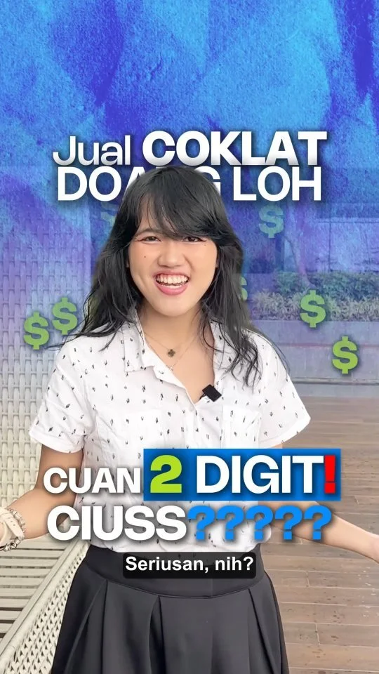 Young woman smiling and pointing, standing in front of a blue textured wall with green dollar signs and game show text in Filipino that reads 'Jual Coklat Dapat Lah' and 'Cuan 2 Digit! Cuss????'