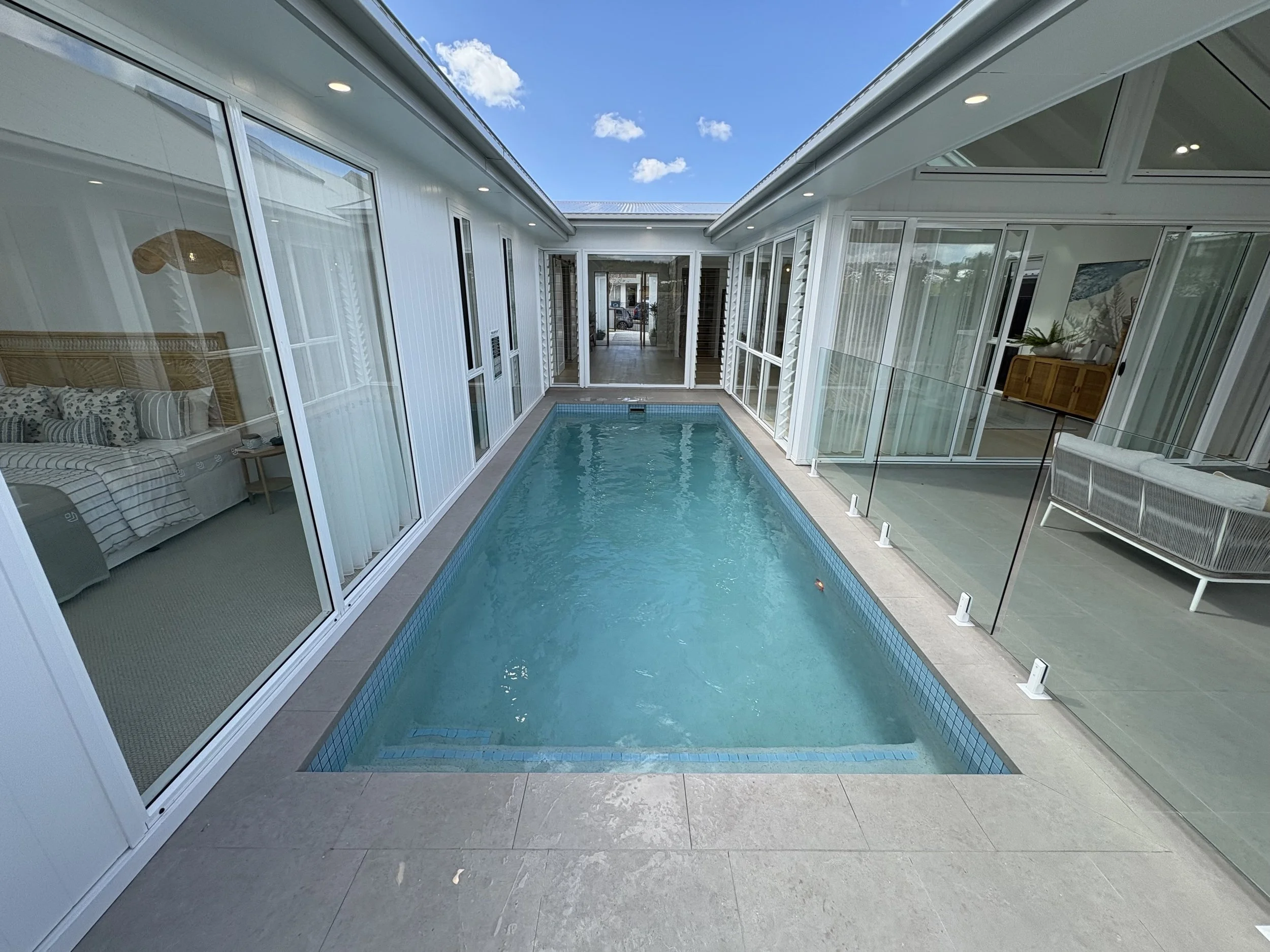 Courtyard goals! 
Great design by #stroudhomes to showcase the pool from every room in the house 
Worongary display home- and yes, the water is really that clear..! 
#poolservices #readyforsummer #chlorine-friendly #pooldesign
