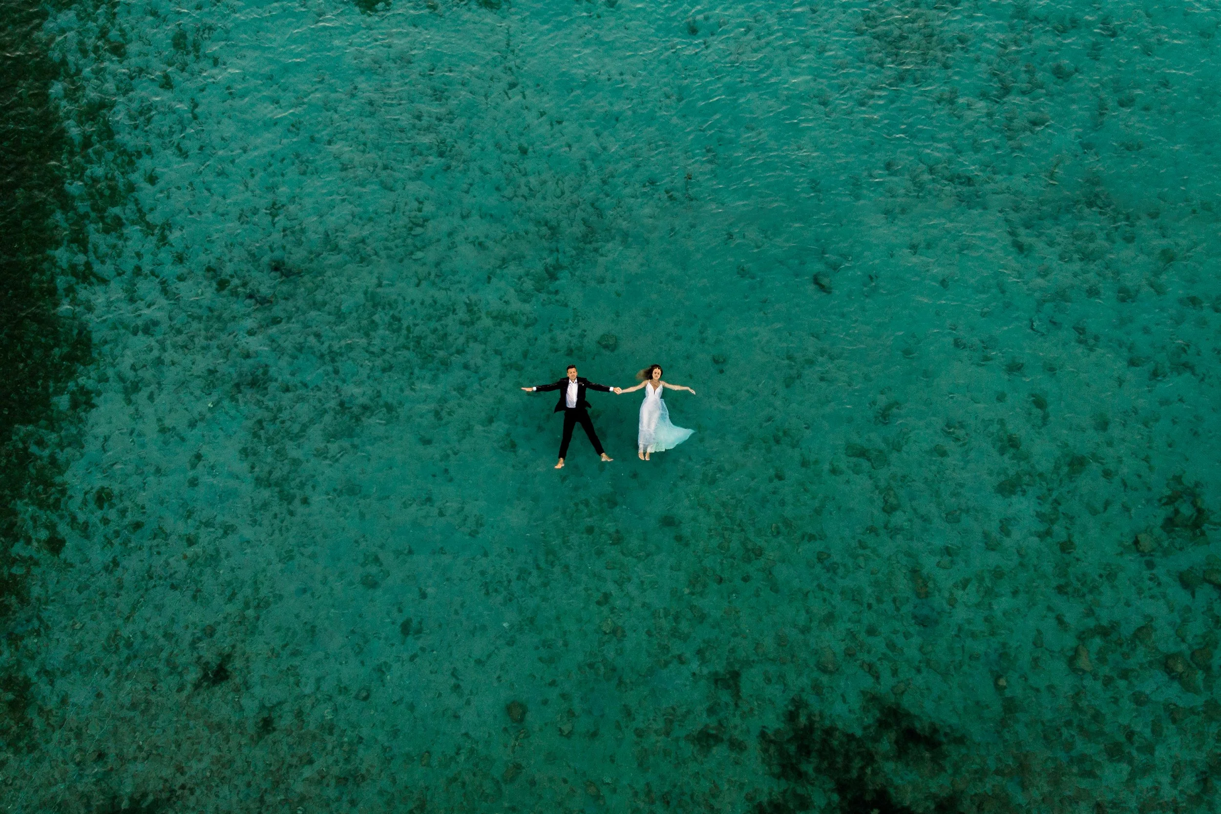 a bride and a groom in the open sea