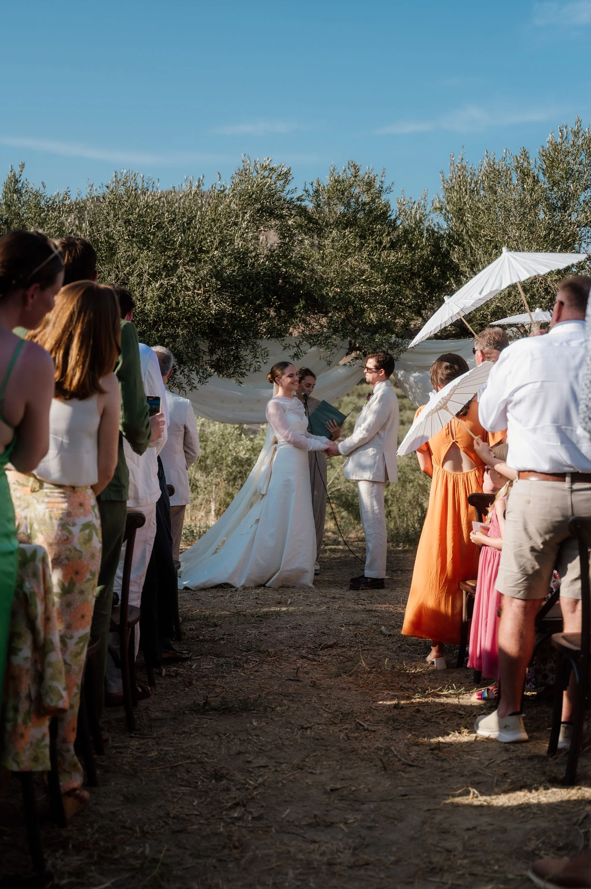a couple in the moment of wedding ceremony in the olive grove in crete