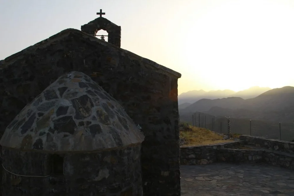 A stone chapel at the top of a mountain