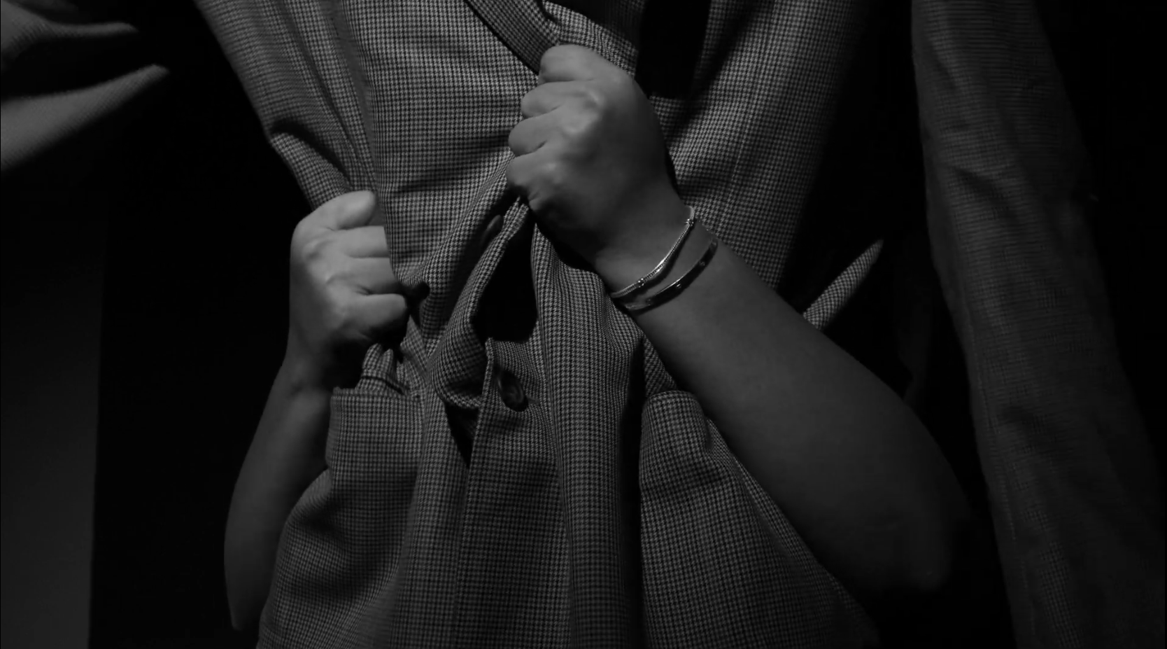 Close-up of a person's hands holding a piece of fabric.