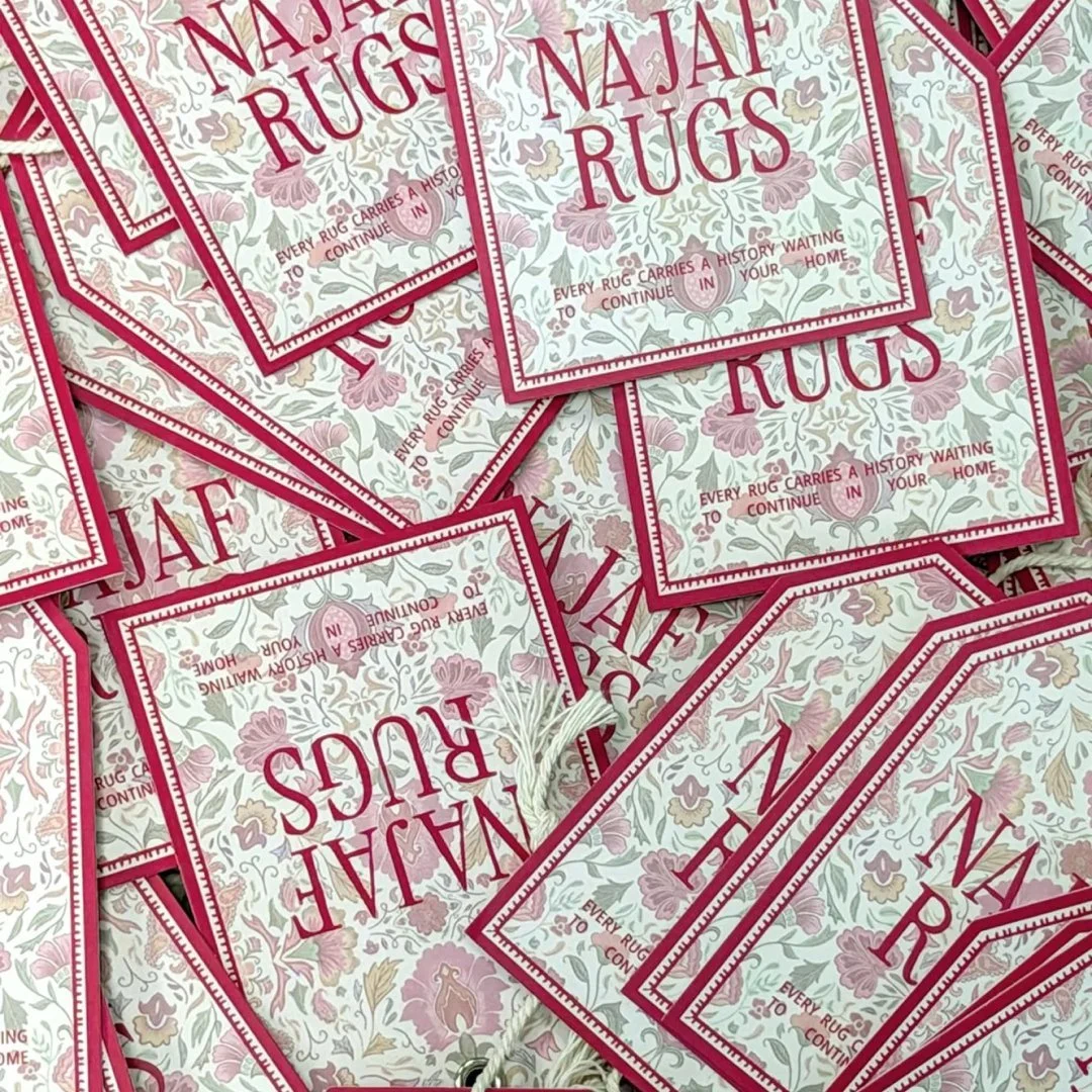 Multiple promotional flyers or cards for Najaf Rugs with floral design and the slogan "Every rug carries a history waiting to continue in your home" printed on them.